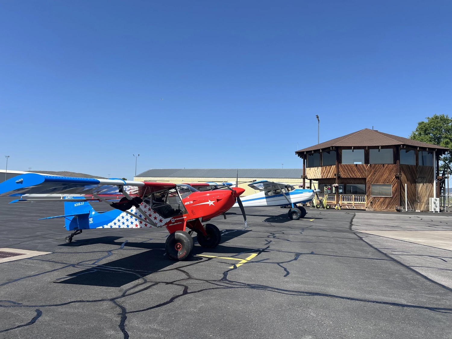 RMC Aviation octagon FBO building and hangar with general aviation aircraft on the ramp